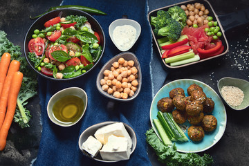 Vegetarian variety dishes on black background.