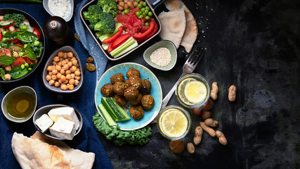 Vegetarian variety dishes on black background.