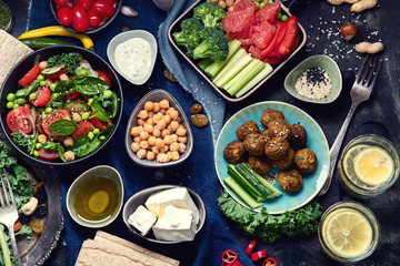 Vegetarian variety dishes on black background.