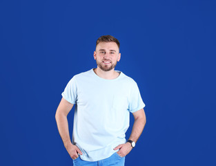 Portrait of handsome happy man on color background