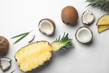 Composition with coconuts and juicy pineapple on white background, top view