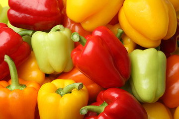 Fresh ripe colorful bell peppers as background, top view