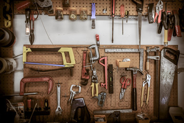 Tools hanging at a home workbench.