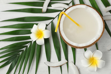 Flat lay composition with half of coconut on white wooden background