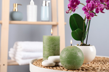 Spa accessories and blooming orchid on table indoors