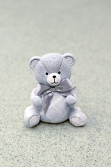 cute teddy bear on abstract blurred backdrop. greeting card background. Concept of birthday, newborn holiday, Valentine's Day. copy space. close up. soft selective focus