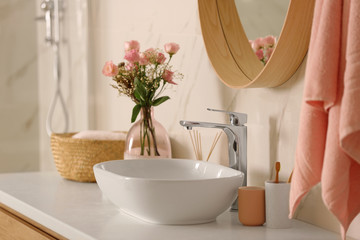 Modern bathroom interior with vessel sink and decor elements