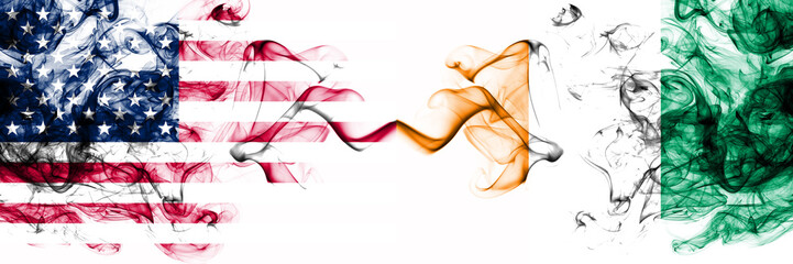 United States of America vs Ivory Coast smoky mystic flags placed side by side. Thick colored silky...