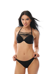 Fototapeta premium Beautiful young woman in black bikini on white background
