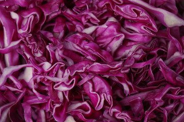 Shredded red cabbage as background, closeup view