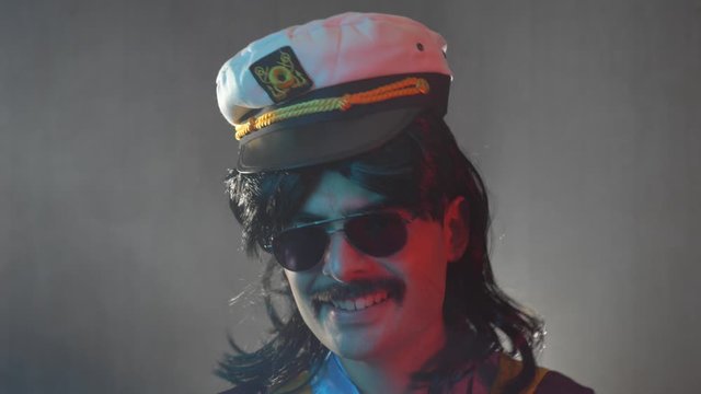 Man with mustache and mullet from the 70s 80s 90 wearing a sailor hat. Vintage concept.