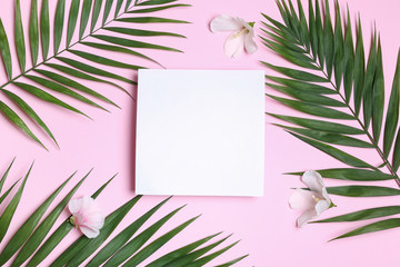 Fototapeta na wymiar Flat lay composition with tropical leaves and Hibiscus flowers on pink background. Space for text