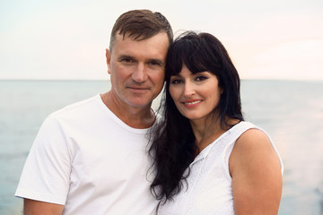Obraz premium Happy mature couple spending time together on sea beach