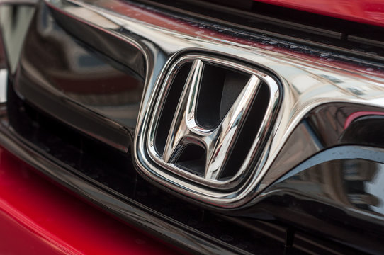 Closeup Of Honda Logo On Red Honda Civic Car Front