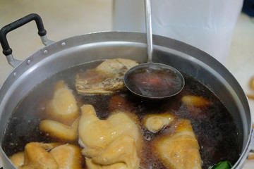 chicken boiling in fish sauce soup. boiled chicken