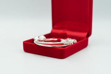 Gift baby is silver anklet in luxury red box.