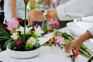 florist arranging flower bouquet in vase. floristry class course workshop - obrazy, fototapety, plakaty