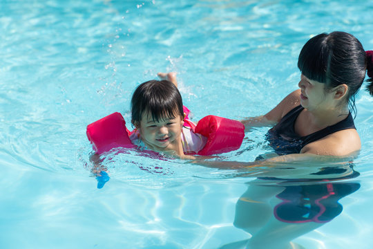 Asian Cute Little Baby Girl Swimming Underwater From Mother.