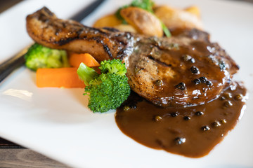 Delicious fresh pork chop with black pepper sauce dipping.
