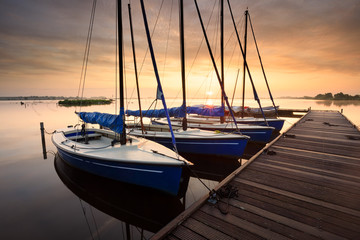 Fototapeta na wymiar serene charming harbor at sunrise with yachts