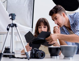 Young photographer working in photo studio