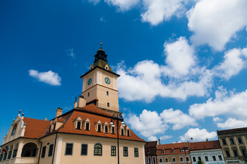 Fototapeta premium The old Town Square of Brasov (Piata Sfatului). The famous City Hall building with the clock tower seen in the background.