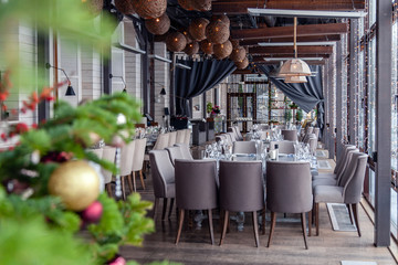 New Year's Christmas interior veranda modern restaurant setting, serving banquet, gray textile...