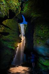 Hidden waterfall Gljufrabui in a canyon. 