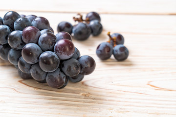 fresh black grapes on white background