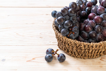 fresh black grapes on white background