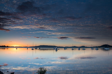 Obraz premium High Clouds, Boats, Reflections and Sunrise on the Bay