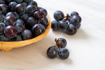 fresh black grapes on white background
