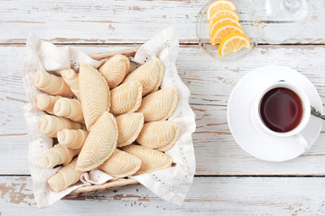 Traditional Azerbaijan holiday Novruz cookies baklava on white plate on the white background with nuts and shakarbura,tea,lemon,kata,mutaki,flat lay,top view,space for copy