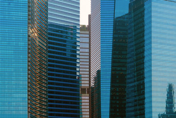 Office buildings windows. Blue glass architecture facade design with reflection of sky in urban...