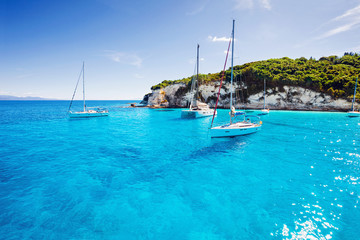 Beautiful bay with sailing boats yachts near the Paxos island, Greece - obrazy, fototapety, plakaty