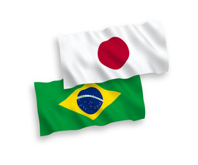 National vector fabric wave flags of Japan and Brazil isolated on white background. 1 to 2 proportion.