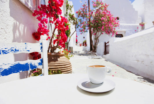Fototapeta Traditional greek coffee in a cafe with beautiful mediterranean street on the background