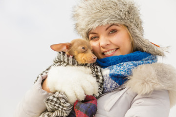 Woman hug warming her dog in cold day