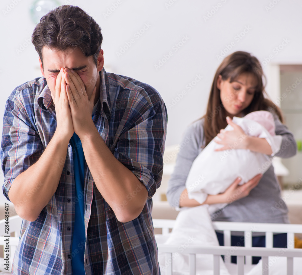 Wall mural Young dad cannot stand baby crying