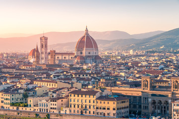 Fototapeta na wymiar Cathedral of Santa Maria del Fiore and Florence rooftops with mountains
