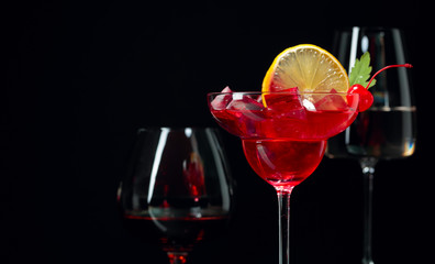 Various alcoholic drinks on a black background.
