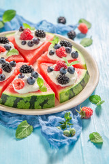 Watermelon pizza with blueberries, raspberries and cream