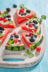 Delicious and tasty watermelon pizza with berries and whipped cream