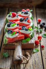 Sweet and tasty watermelon pizza with berries and whipped cream
