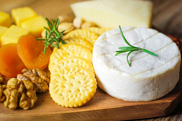 cheese plate,camembert cheese ,rosemary ,crackers,dry apricot and walnuts