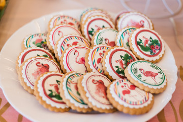 colorful cookies decorated with flamingos on a plate