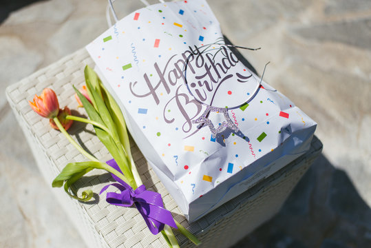 bag with a happy birthday tag and tulips 
