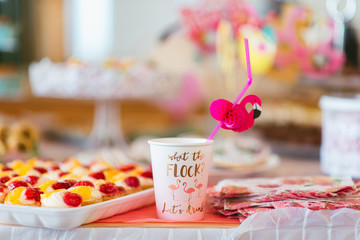 party decoration with a paper cup and flamingo straw 