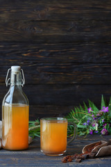 kvass in a glass cup and a bottle