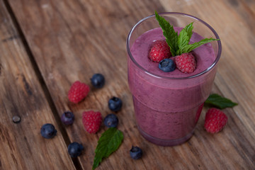 Smoothie with raspberries and blueberries with mint leaves